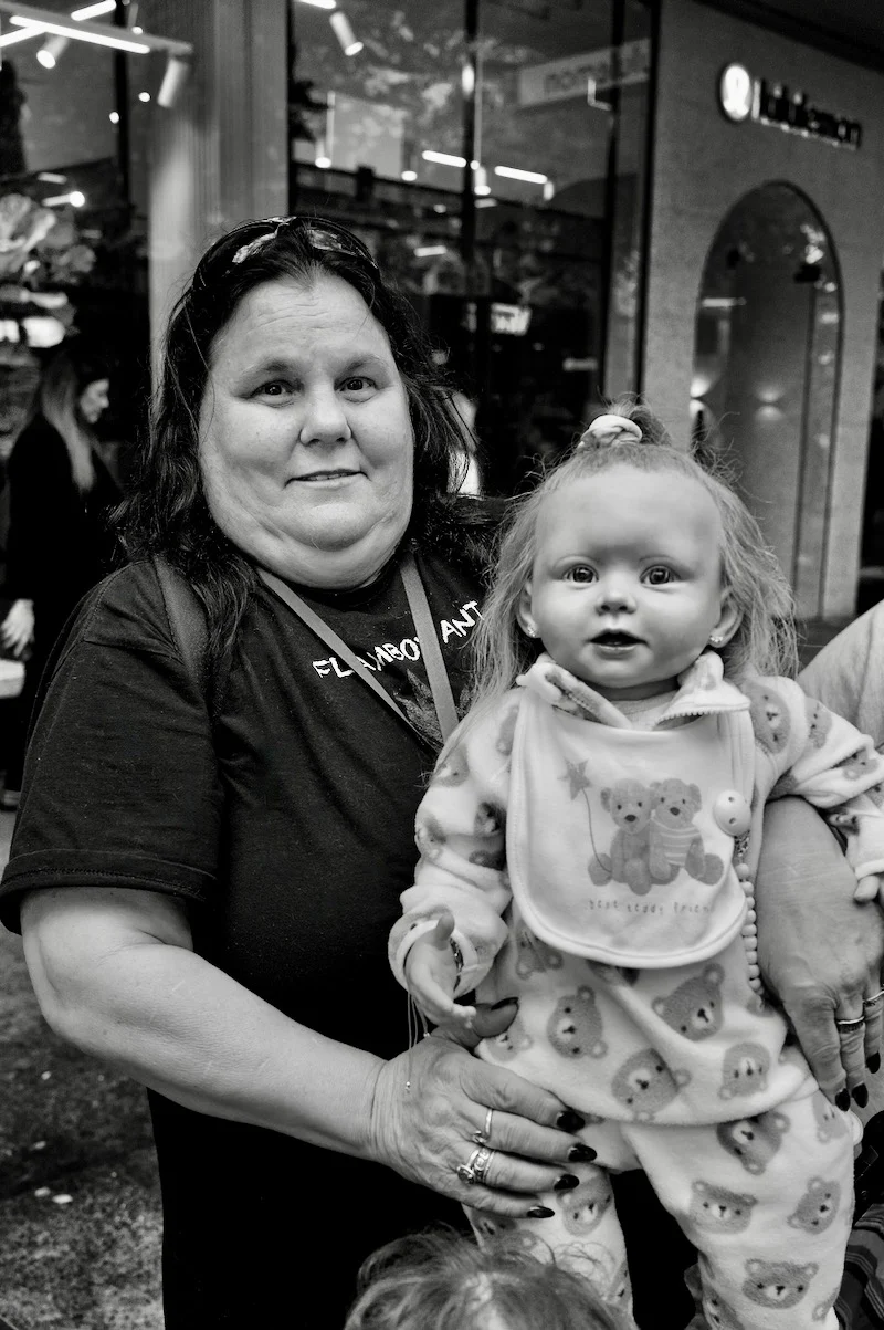 A lady with one of her adopted children - a doll! - by Peter Pickering
