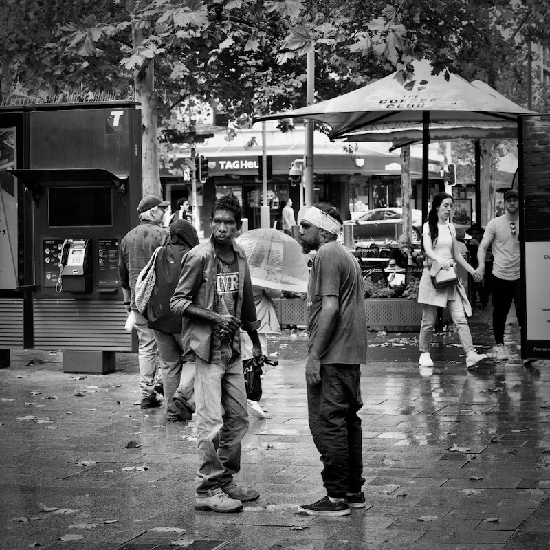 Two aboriginal men in a face-to-face discussion in the street photographed by Peter Pickering